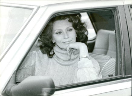 Sophia Loren stares out from inside a car