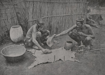 South Africa. Zulu preparing a skin for wear. Photogravure from a photograph by Mr. G.T.
