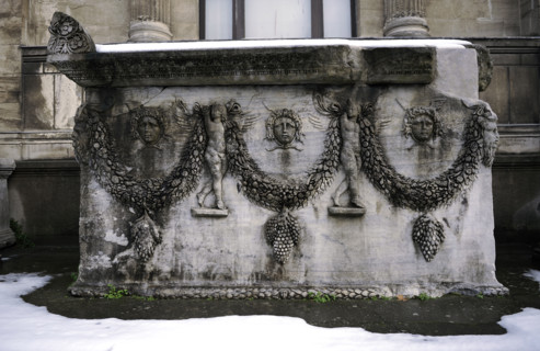 Roman sarcophagus decorated with reliefs of Gorgoneions and garlands, supported by Erotes. From