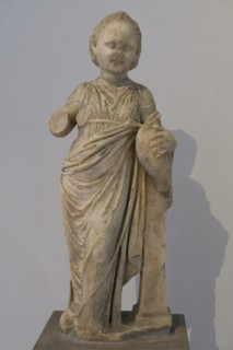 Statue of a little girl holding a goose; a common type of votive offering to ancient sanctuaries.