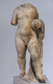 Statue of a small boy holding a ball; votive offering to a certain sanctuary in Piraeus.
