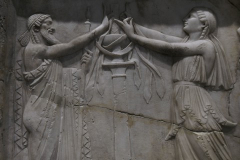 Ancient Greece. Priest and priestess in a ritual attitude. Detail of a relief slab. Marble.