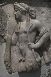 Relief slab depicting four deities in procession. Detail of Apollo. Marble. Archaeological Museum