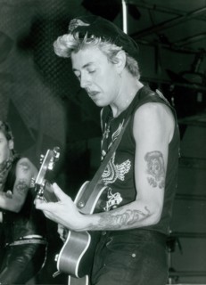 Brian Setzer playing guitar at a Stray Cats concert