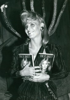 Britt Ekland holding two copies of her book ""True Britt"" at Starbucks Restaurant and Disco in New York