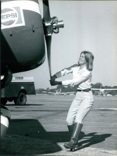 Pepsi Skywriter Susanne Asbury turning the propeller before taking off, circa 1980s