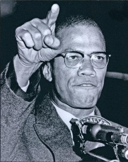 Malcolm X at microphone