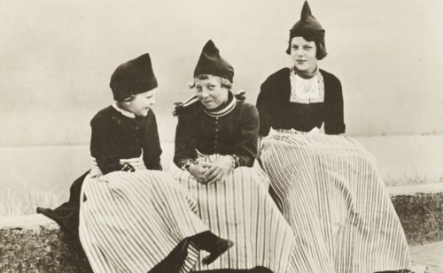 Three girls wearing The Netherlands typical costume