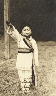 A child posing in traditional Romanian costume