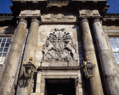 SCOTLAND, Lothian, Edinburgh, Holyrood House. Ornate crest above door with stone columns and wall