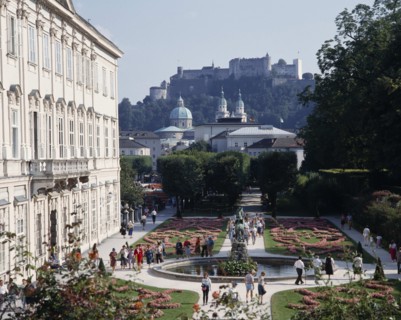 AUSTRIA, Salzburg Province, Salzburg, Mirabell Palace with tourists walking in the formal gardens