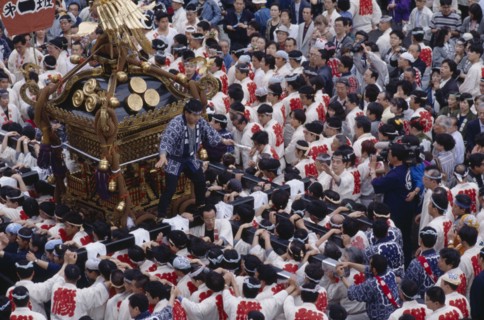 JAPAN, Honshu, Tokyo, Men carrying Mikoshi Shrine through the street during a festival