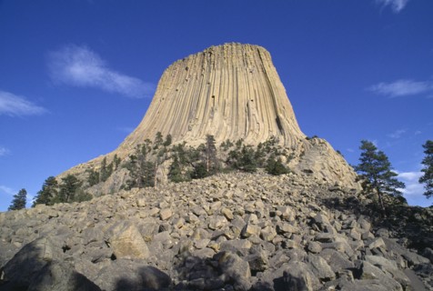 USA, Wyoming, Devils Tower, 867ft high National Monument of volcanic outcrop with bolders leading