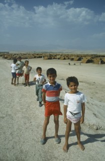 TURKEY, Sirnak, Silopi, Group of Kurdish refugee children at Haji Camp with rows of tents behind