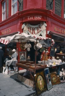 ENGLAND, London, Portobello Road antique shop in the market with a stall outside on the pavement