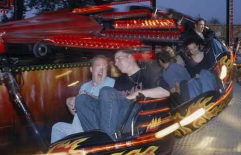 ENTERTAINMENT, Funfair, People on a funfair ride at night with movement blur