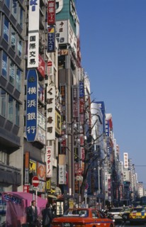 JAPAN, Honshu, Tokyo, Advertising down the side of buildings in the Shinjuku district with the