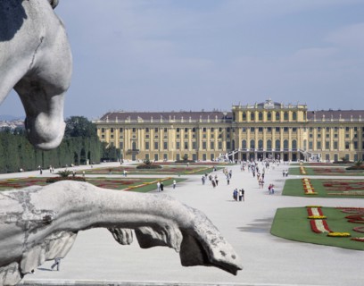 AUSTRIA, Lowe Austria, Vienna, Schonbrunn Palace and tourists walking in the formal gardens with a