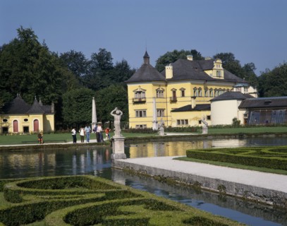 AUSTRIA, Salzburg Province, Salzburg, "Hellbrunn Palace, a yellow building behind an ornamental
