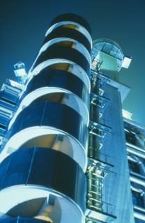ENGLAND, London, Lloyds Building designed by Richard Rogers.  Exterior at night.