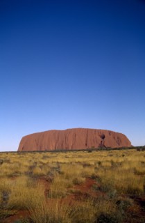 AUSTRALIA, Northern Territories, Ulhuru, Ayres Rock in desert landscape.