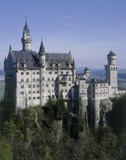 GERMANY, Bavaria, Fussen, Neuschwanstein Castle of King Ludwig on a rocky hill amongst trees