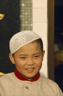 CHINA, Gansu, Lanzhou, Moslem boy wearing velvet beaded cap