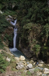 PHILIPPINES, Luzon, Near Baguio, "Waterfall,greenery on rocks,boulders in stream "