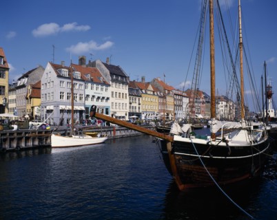 DENMARK, Zealand, Copenhagen, Nyhavn harbour. Traditional waterfront buildings with moored boats