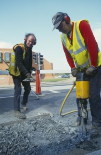 ARCHITECTURE, Construction, Roadworks, Workmen with pneumatic drill digging up the road