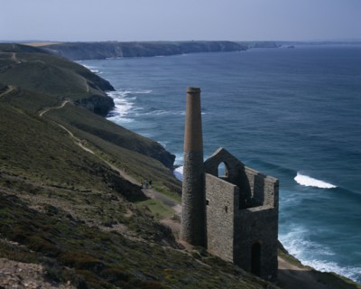 ENGLAND, Cornwall, St Agnes. Coastline with stone building and chimney next to coastal path