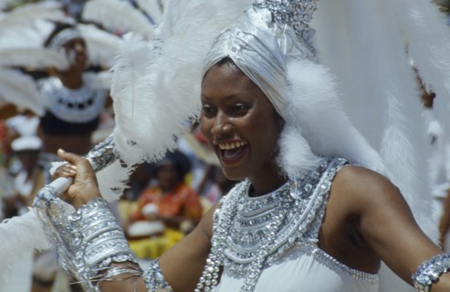 WEST INDIES, Barbados, Crop Over, Woman in silver and white costume at traditional harvest festival