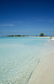 CUBA, Isla De Juventud, Cayo Largo, Playa Sirena with couple walking along the beach near the