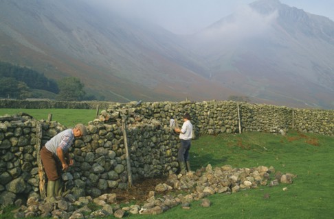ARCHITECTURE,  , Walls, Men reparing drystone wall Wasdale Head Lake District