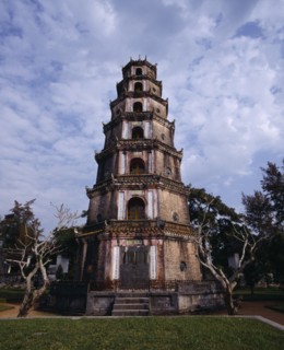 VIETNAM, Central, Hue, "Thien Mu Pagoda,tiered brickwork,trees & dead trunks,mottled sky "