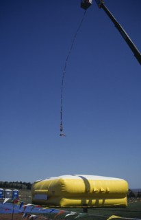 SPORT, Bungee Jumping, "Giant crane with jumper suspended over large inflatable, Rapid City, South