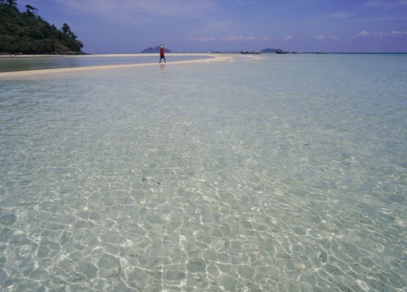 THAILAND, Krabi, Phi Phi Don, Lobagao Bay on the north coast of the island with a man in red