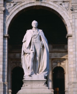 INDIA, West Bengal , Calcutta, Statue of Lord Curzon on pedestal framed by stone archway.