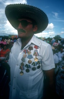 CUBA, Santiago, Veteran at memorial with shirt adorned with medals