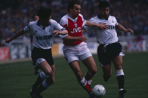 10051517 SPORT Ball Games Football Players tackle in Arsenal versus Spurs match.