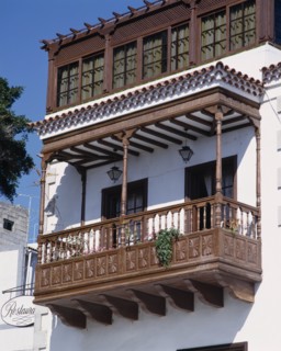 SPAIN, Canary Islands, Tenerife, Traditional ornate wooden balcony on whitewashed house