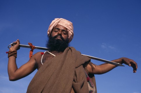 INDIA, Delhi , SIkh man holding Holy Kirpan Sword for the defence of the weak.  Three-quarter view