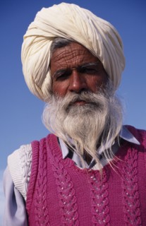 INDIA, Punjab, Amritsar , "Elderly bearded Sikh man, head and shoulders portrait wearing white