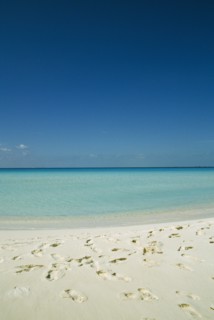 CUBA, Isla De Juventud, Cayo Largo, Playa Serena looking out to sea with footprints in the sand