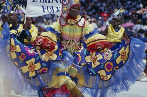 WEST INDIES, Barbados, Crop Over, Man in multicoloured costume at traditional harvest festival to