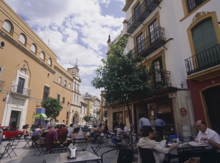 SPAIN, Andalucia, Seville, "Santa Cruz District, Calle Santa Maria la Blanca with people sitting at