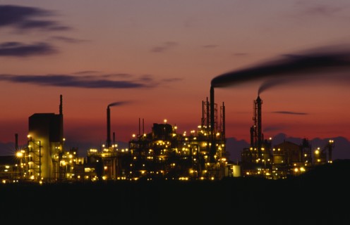 INDUSTRY, Factory, Refinery, Grimsby petrochemical plant illuminated at dusk.  Buildings and smoke