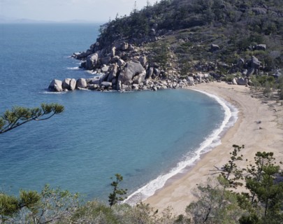 AUSTRALIA, Queensland, Magnetic Island, Arthur's Bay looking down onto  deserted beach with rocks