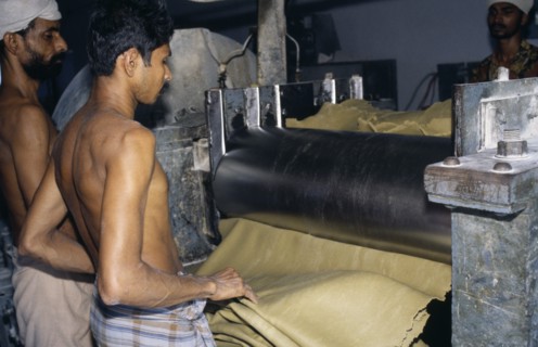 INDIA, Kerala, Industry, Workers in rubber factory.