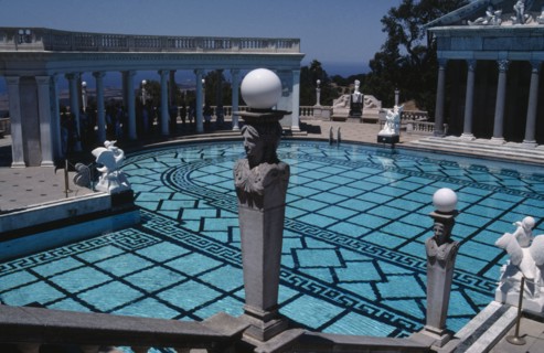 USA, California, Randolph Hearst Castle, Greek Pool with columned surround and people gathered in